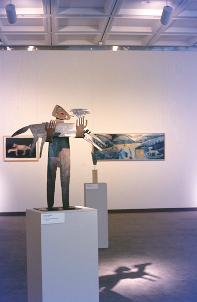 sculpture of figure holding a dog